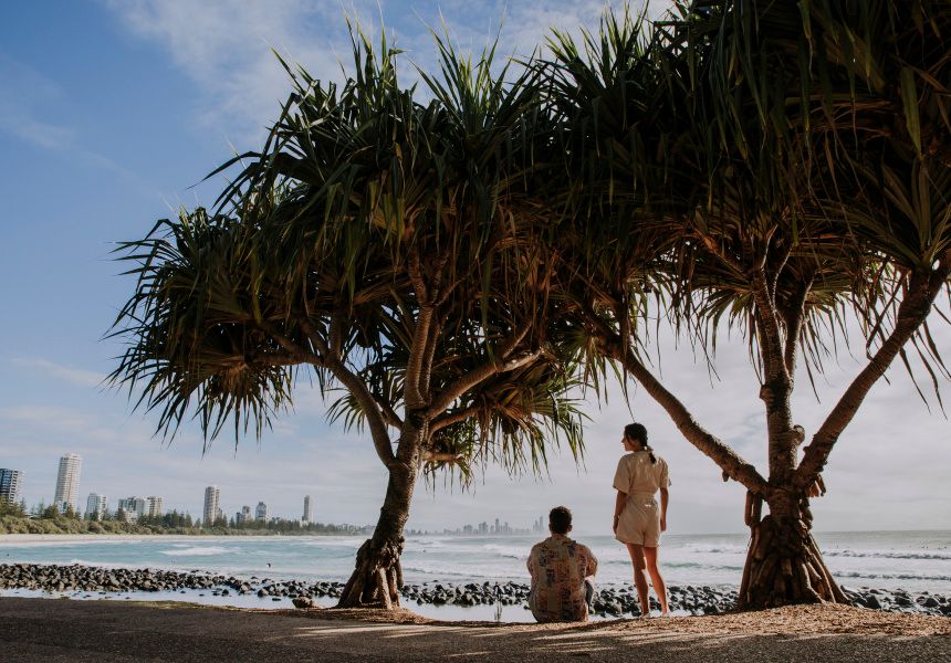 Couple watching the waves with Surfers Paradise on horizon
